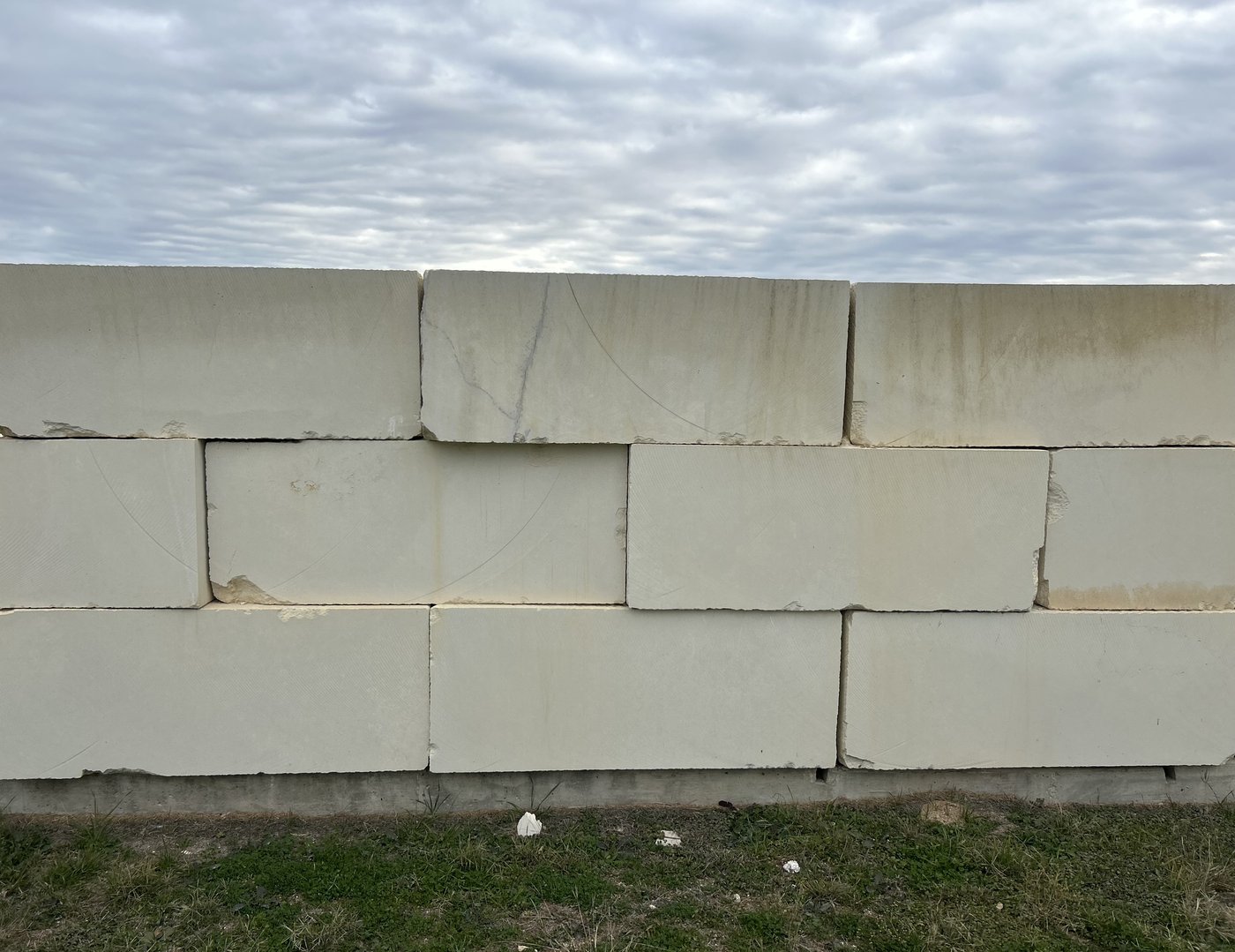 Massive cream limestone block retaining wall — large dimensional blocks set in a stacked-bond pattern