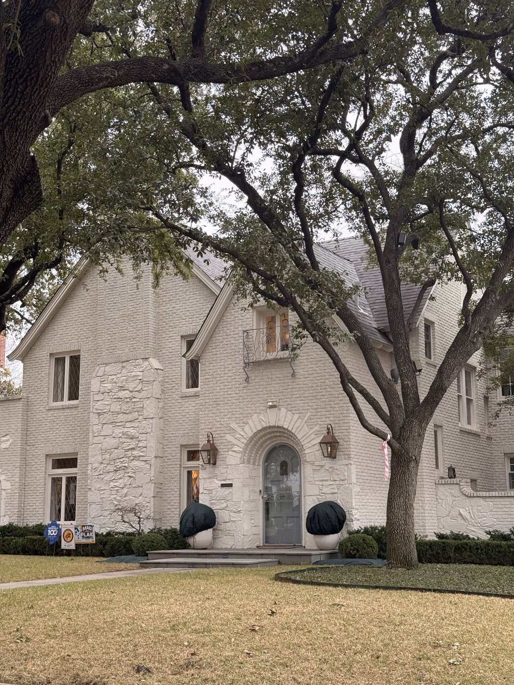 Whitewashed brick residence — Alaska Flagstone above the arched entry with custom oversized Wichita White surround and wainscot