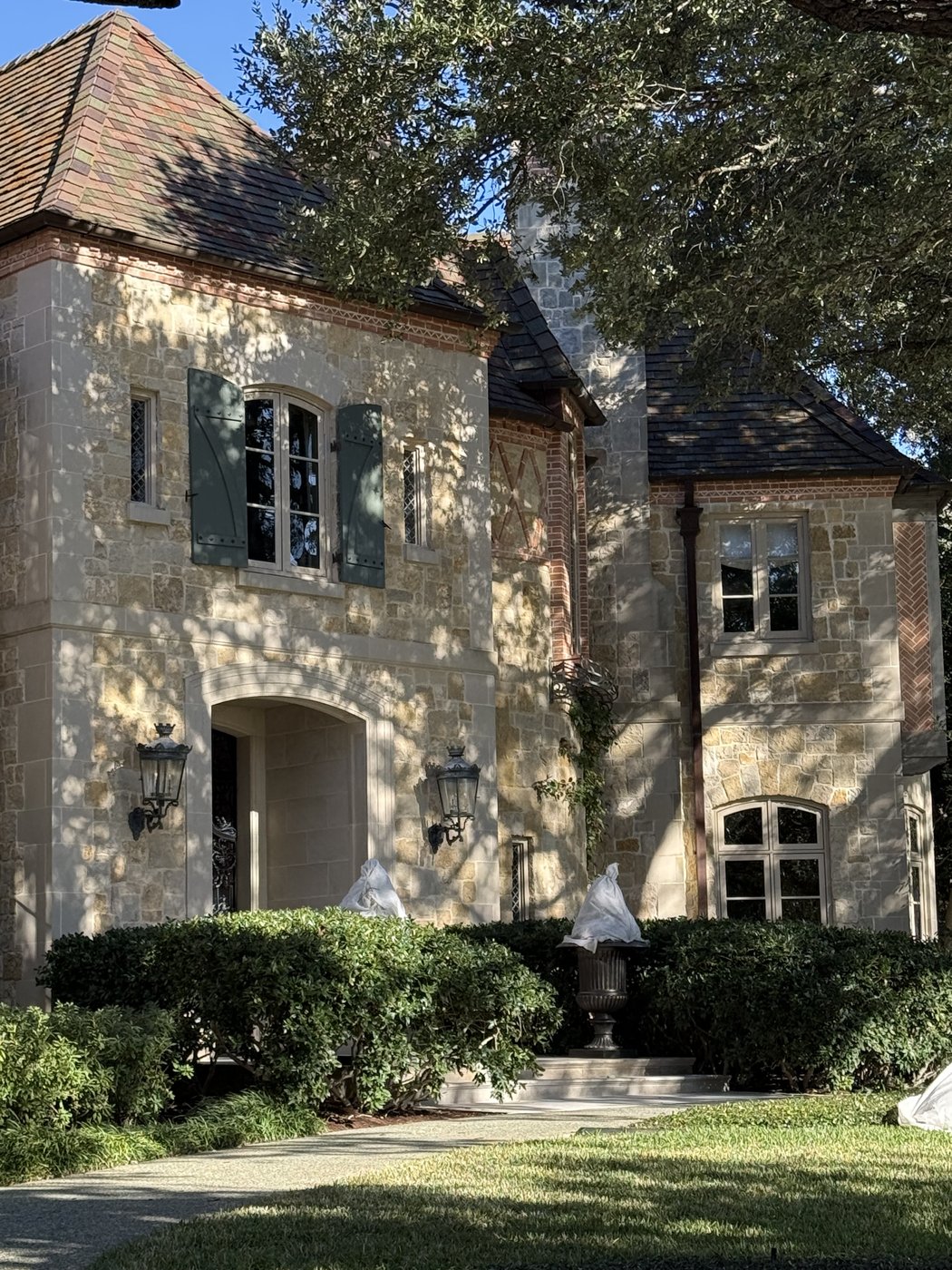 Old-World residence — Antique chopped courtyard side with arched openings and clay-tile roof