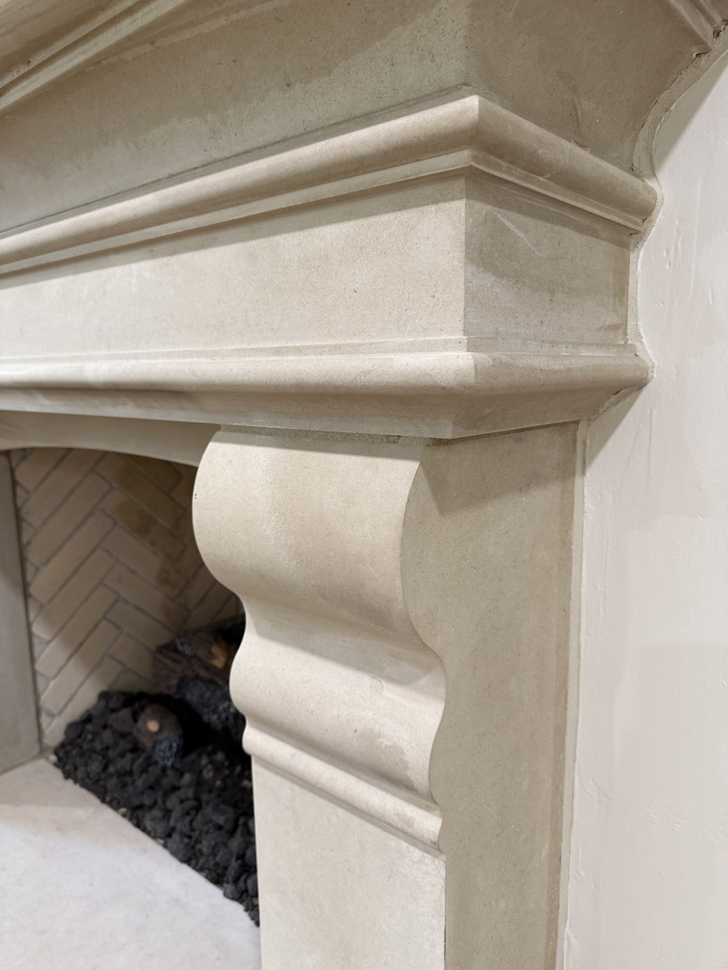 Detail of the custom-carved Castle Grey fireplace corbel and mantel profile