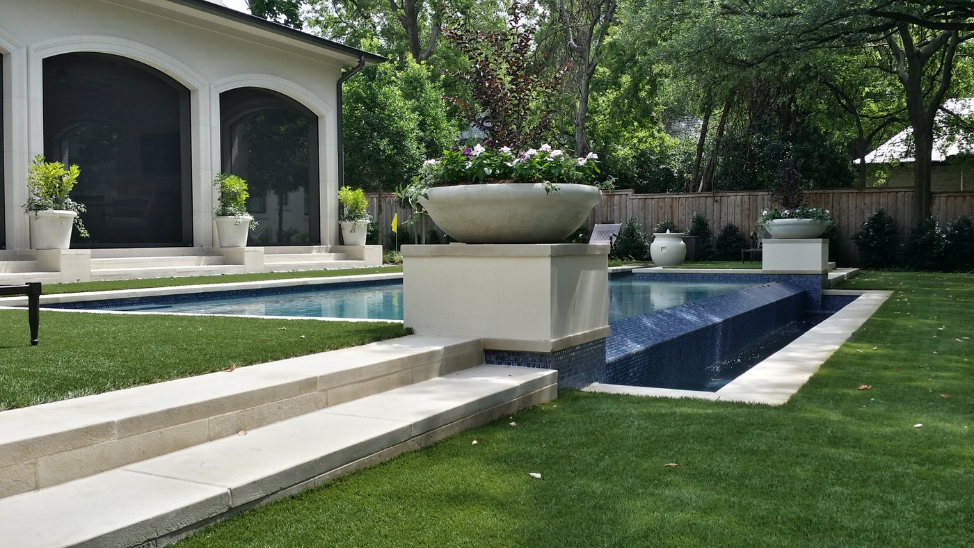 20 inch ledge Castle Grey pool coping wrapping a residential pool with a water-bowl pedestal