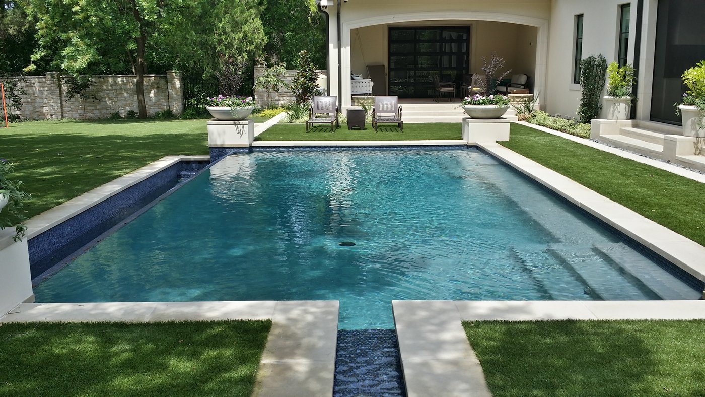 20 inch ledge Castle Grey tile and coping around a residential pool with covered patio in view