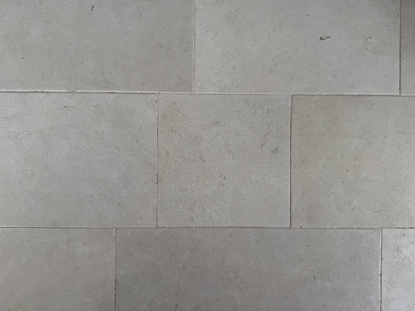 28 inch ledge Castle Grey limestone flooring with an aged honed top — large tiles in an offset pattern