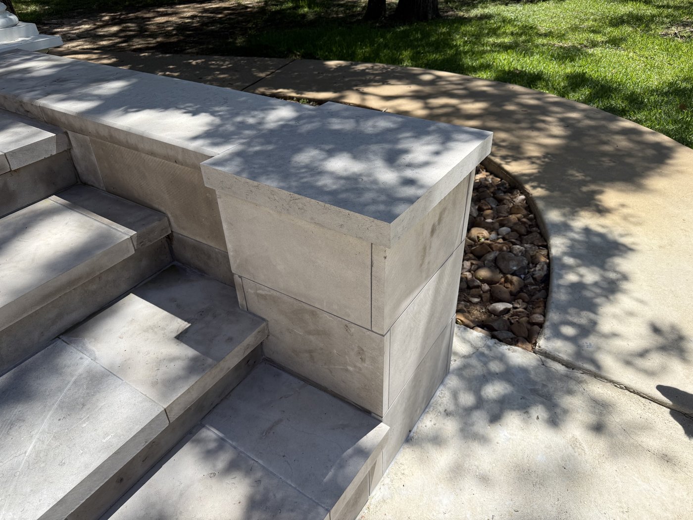 Honed charcoal 1 inch tile cladding and 2 inch stair treads with a wall cap, residential entry