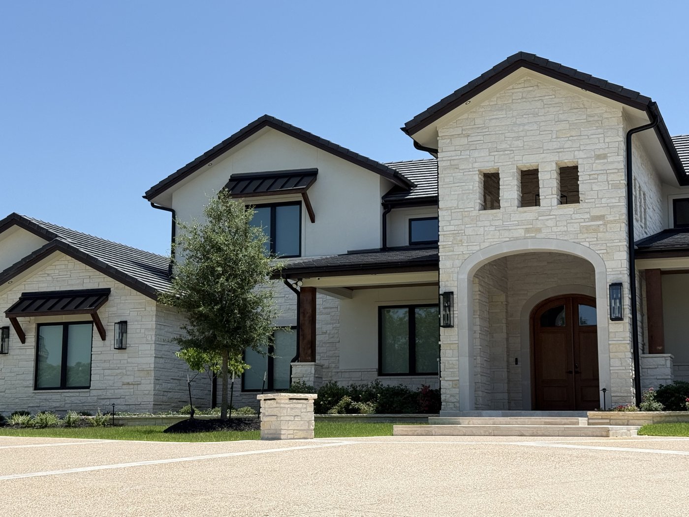 Hill Country residence — Cordova Cream dimensional ashlar in 2-4-6 inch courses, front entry with arched stone tower