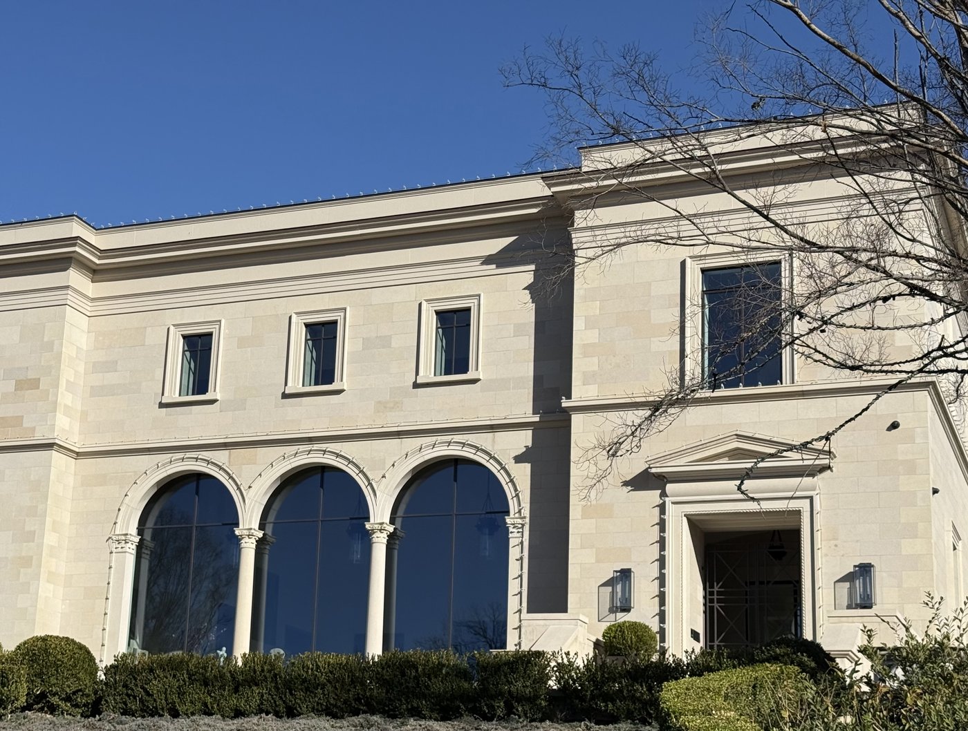 Classical estate — Crescent Cream triple arched window detail with carved column capitals
