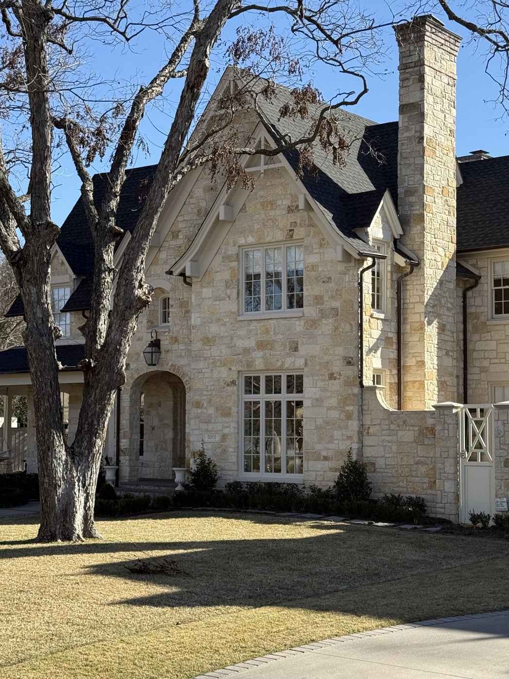 Tall steeply-pitched residence — Goldstone chopped random ashlar wrapping the full elevation