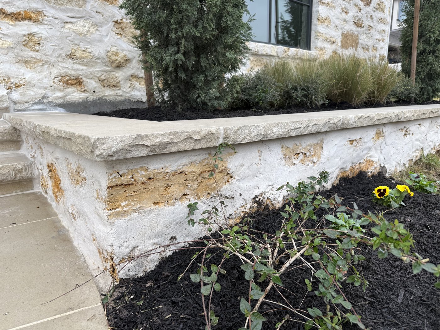 Italian villa — Granada Grey wall caps on a Cavestone planter wall with heavy smear joint