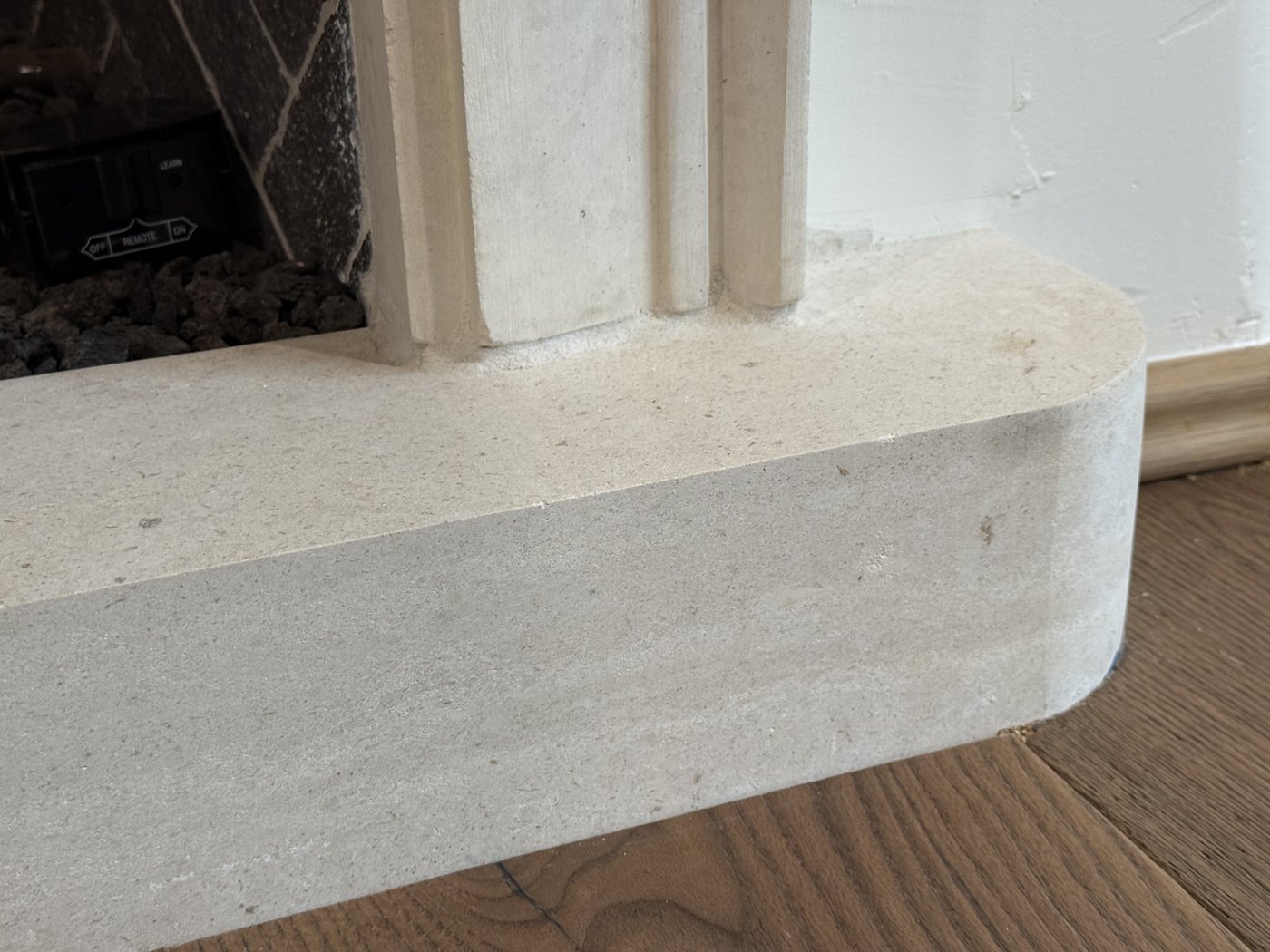 Carved white limestone fireplace hearth with curved ends