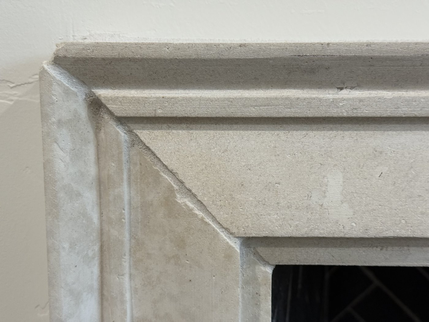 Carved white limestone fireplace surround — molding profile corner detail