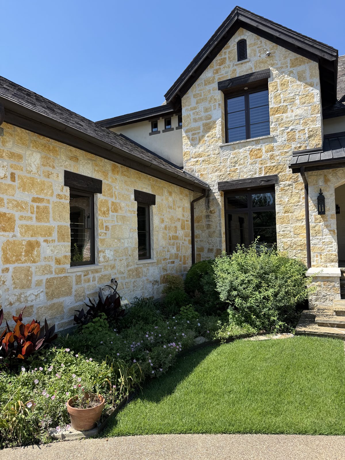 Hill Country residence — Rattlesnake Chop random ashlar courtyard facade with oversize feature pieces and full-height windows