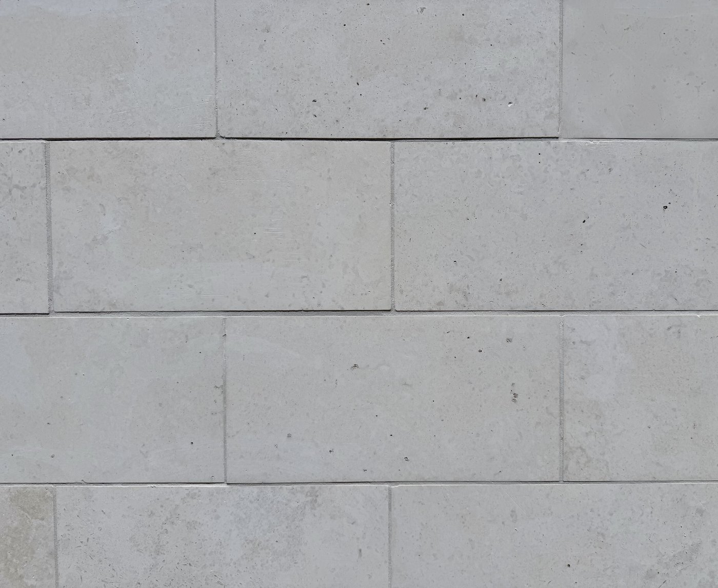 Whitewing close-up — 12 by 24 inch honed limestone blocks in a running-bond facade