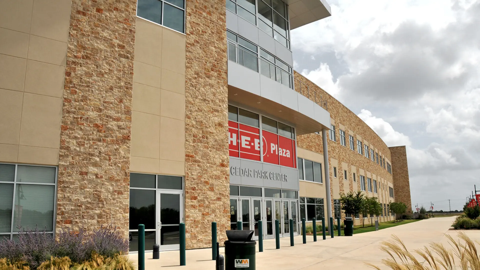 A large brick building with a red sign on the front.