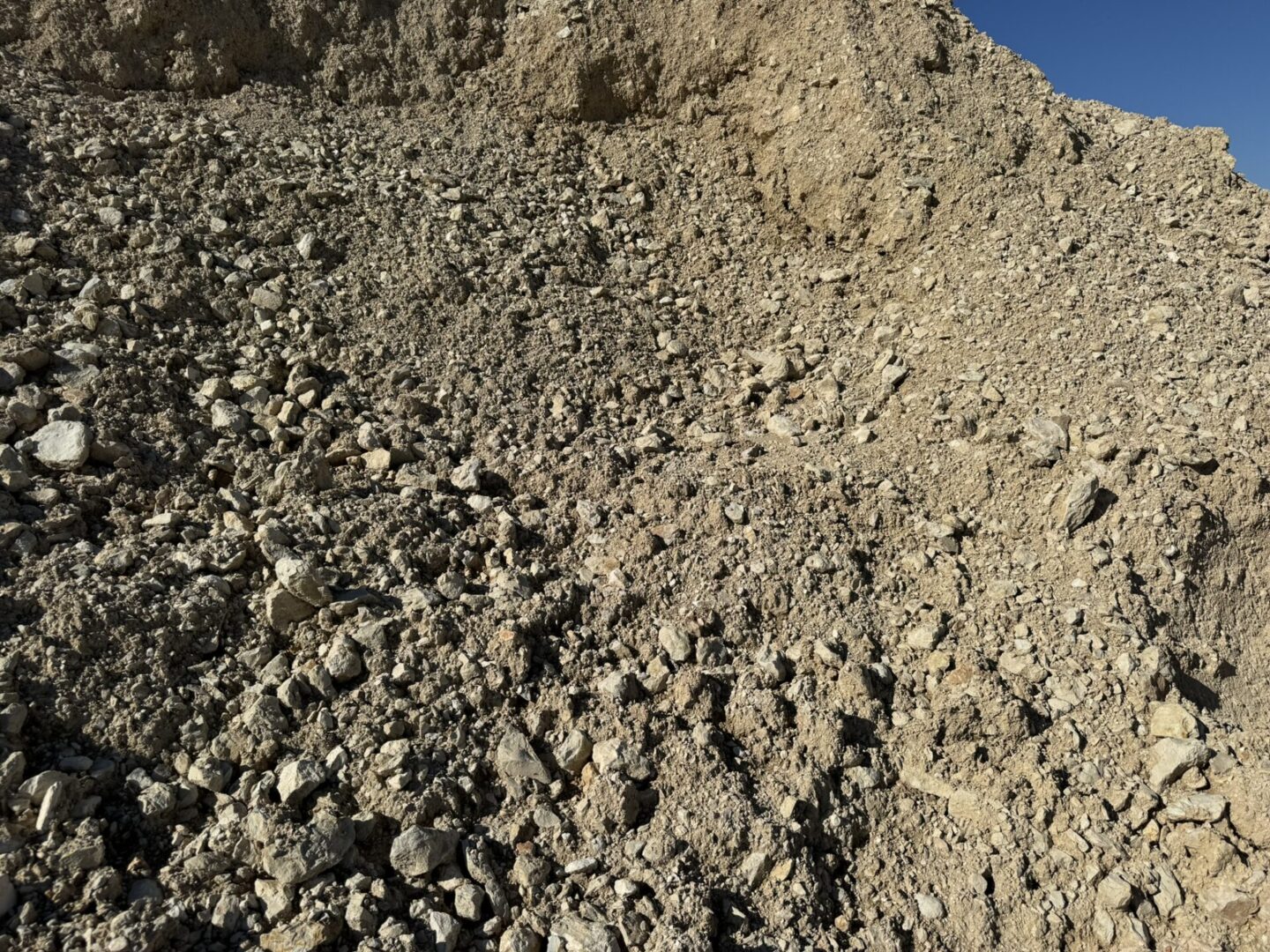 A pile of gravel on top of a hill.