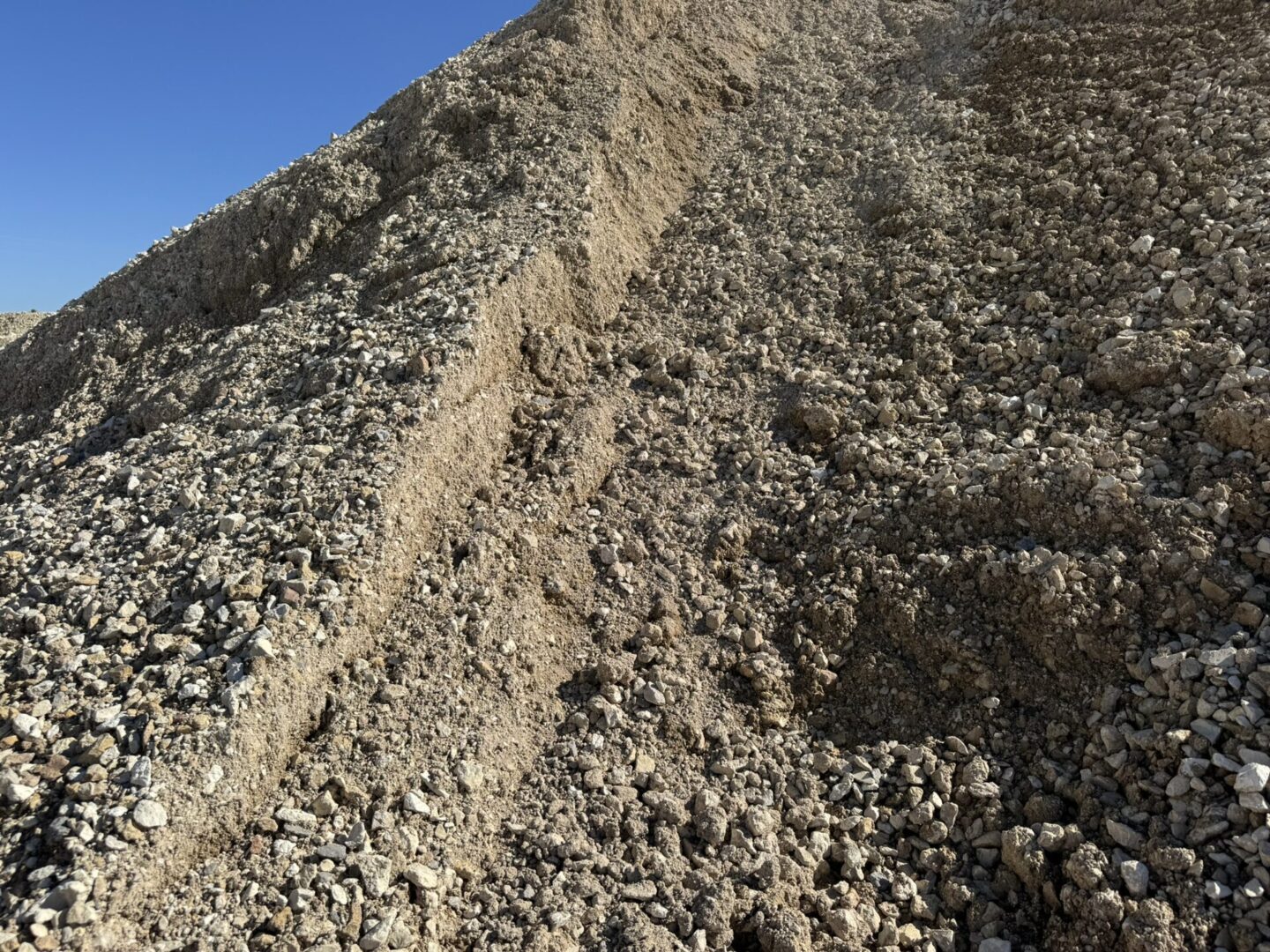 A pile of gravel on top of a hill.